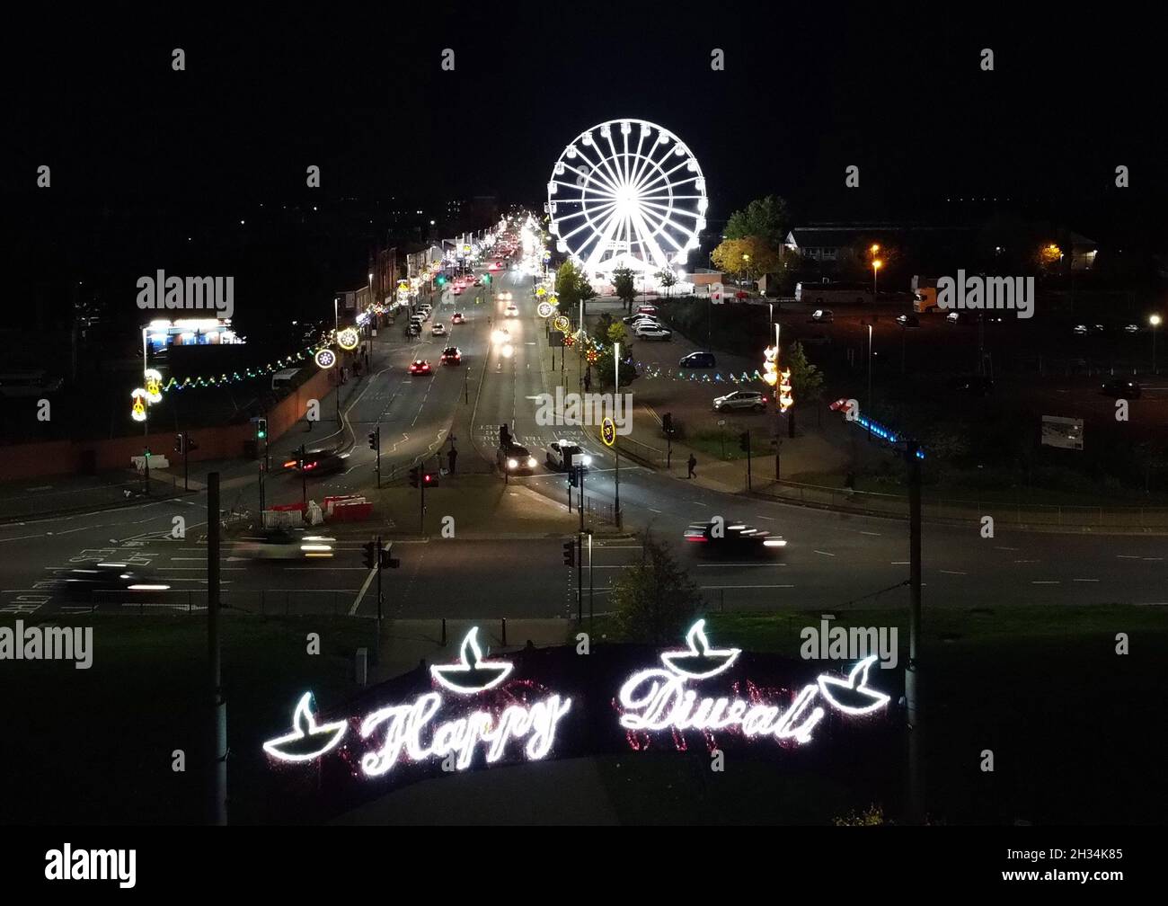 Leicester, Leicestershire, UK. 25th October 2021. A ferris wheel turns in front of Diwali lights on the Golden Mile. With over 6,500 lights the Diwali celebrations in Leicester are regarded as the largest outside of India. Credit Darren Staples/Alamy Live News. Stock Photo