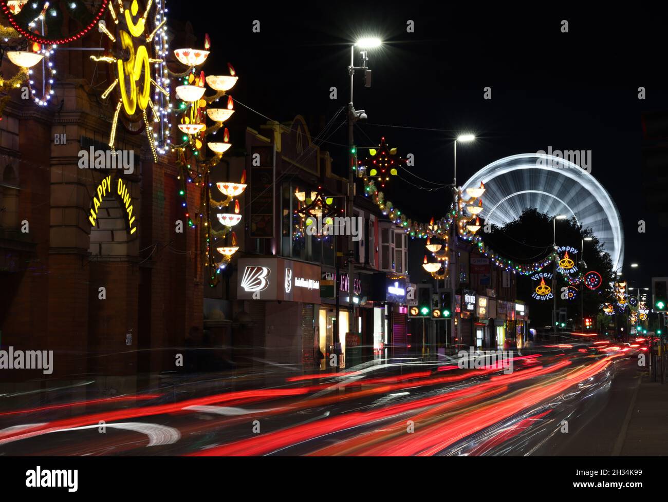 Leicester, Leicestershire, UK. 25th October 2021. Cars leave light trails as they pass Diwali lights on the Golden Mile. With over 6,500 lights the Diwali celebrations in Leicester are regarded as the largest outside of India. Credit Darren Staples/Alamy Live News. Stock Photo