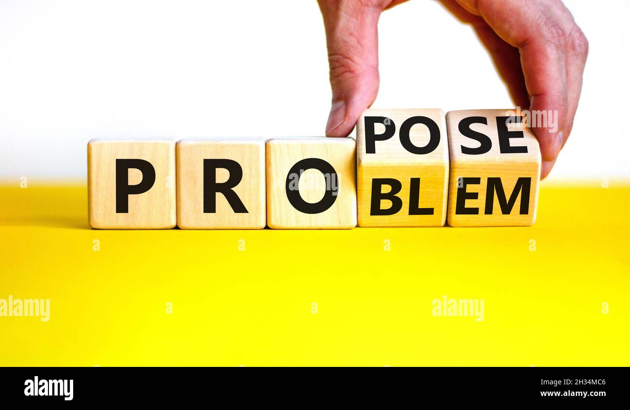 Solving a problem and propose symbol. Businessman turns wooden cubes ...