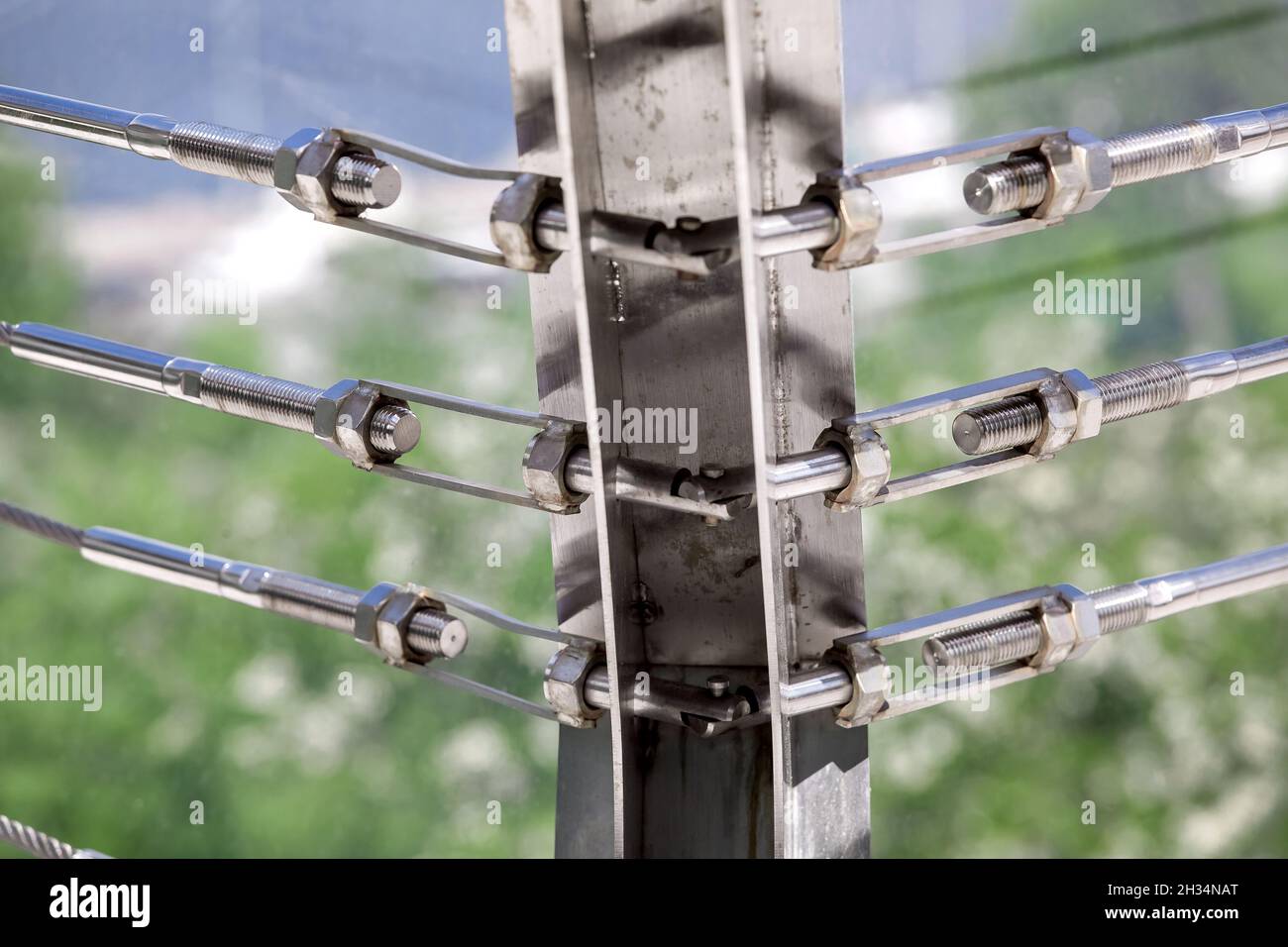 corner fixing system on the frame of lock sling steel and screw, a detail of frame on glass bridge with fastening engineering construction stainless s Stock Photo