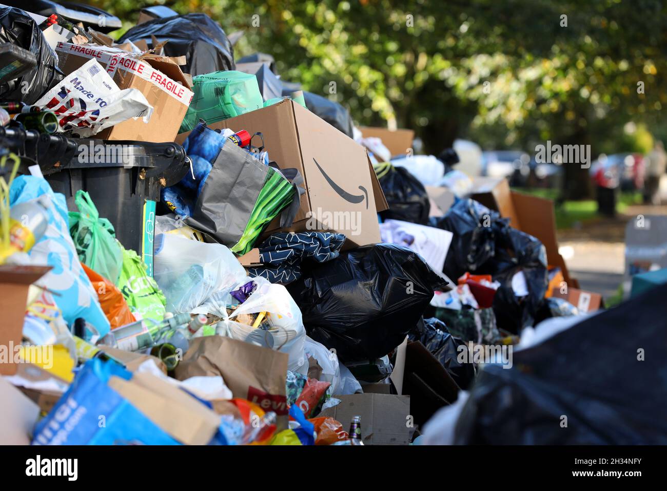 Huge piles of rubbish piled up next to bins in Brighton, East Sussex, UK, during the bin man strike when unions were fighting with the Green party. Stock Photo