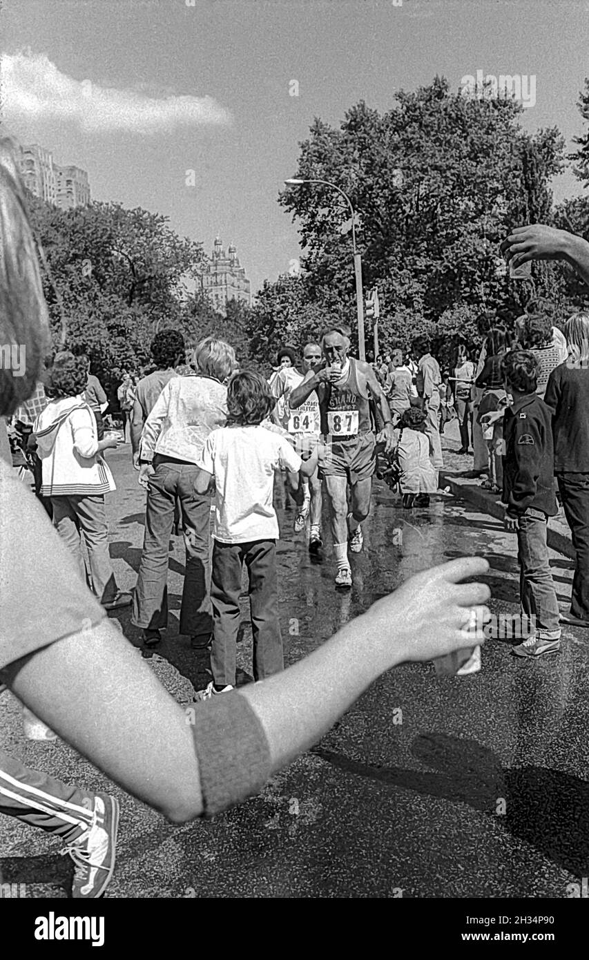 Runner at water stop competing in  the 1973 New York City Marathon. Stock Photo