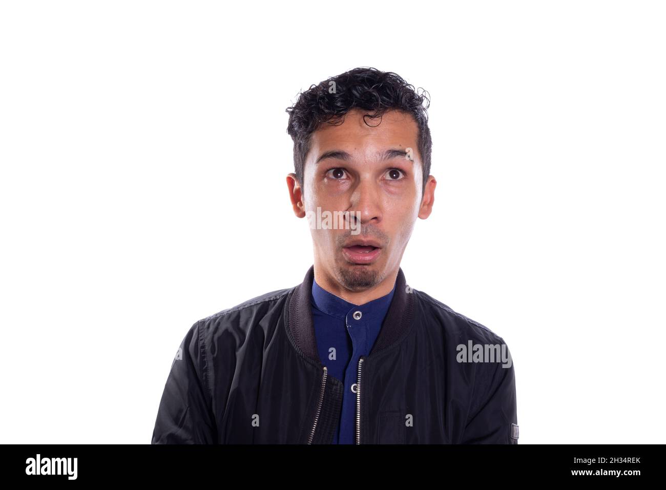 Man with idiot face isolated on white background. Young adult making silly face. Stupid face theater. Stock Photo