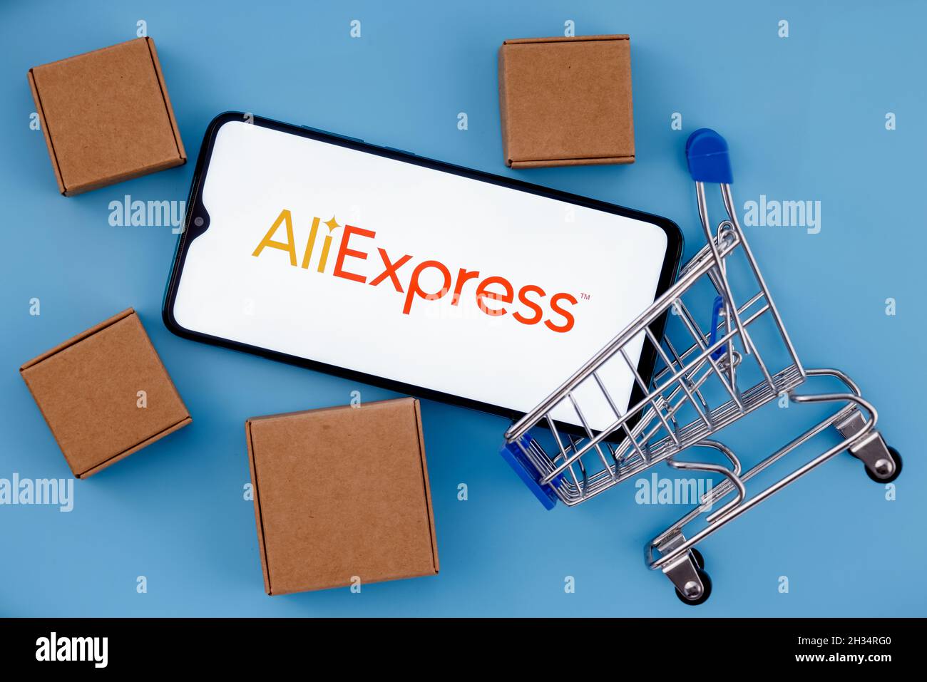 AliExpress is an Chinese online retail service. Smartphone with AliExpress  logo on the screen, shopping cart and parcels Stock Photo - Alamy