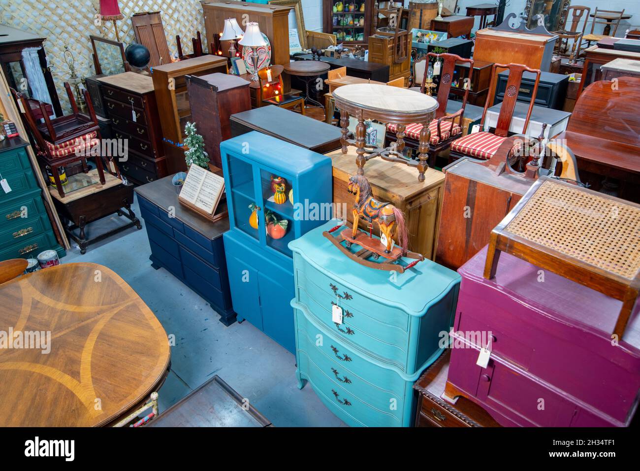 A warehouse full of used refinished furniture for sale.  Fairfax Virginia USA Stock Photo