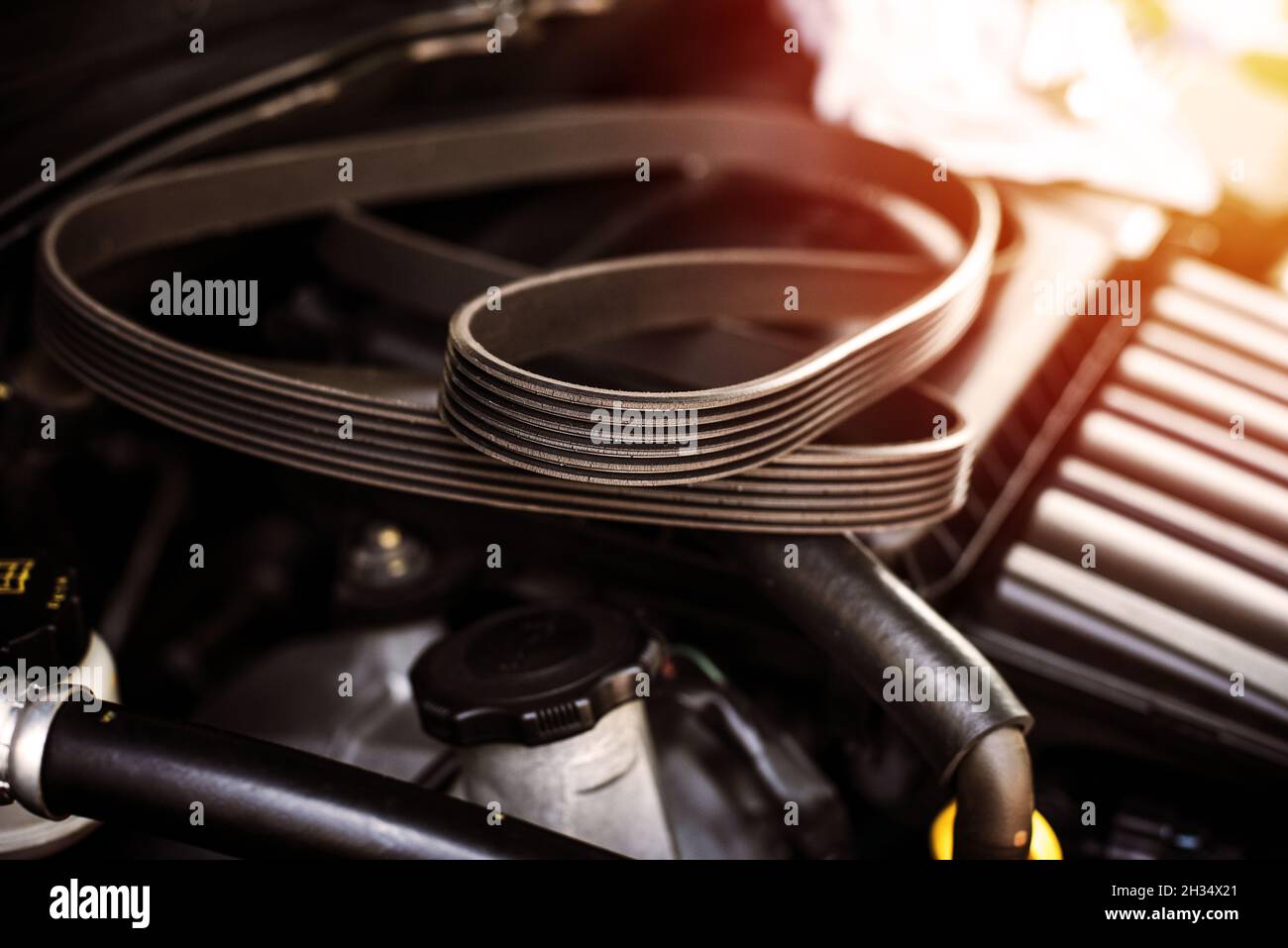 closeup old timing belt with many cracks in the engine room Stock Photo