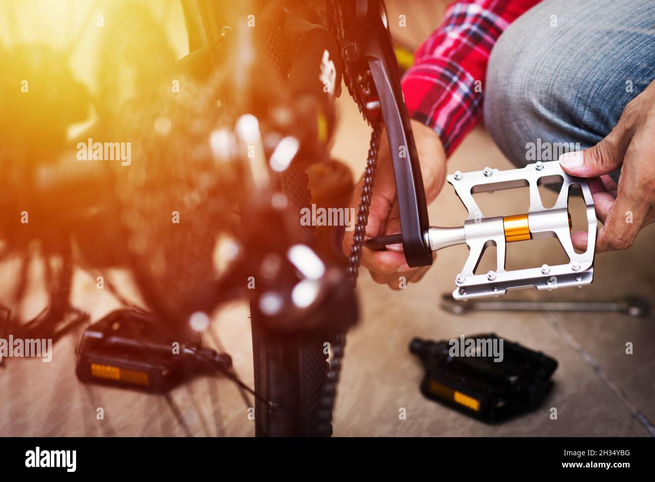 The man changing bike pedals. Mountain bike upgrade concept Stock Photo