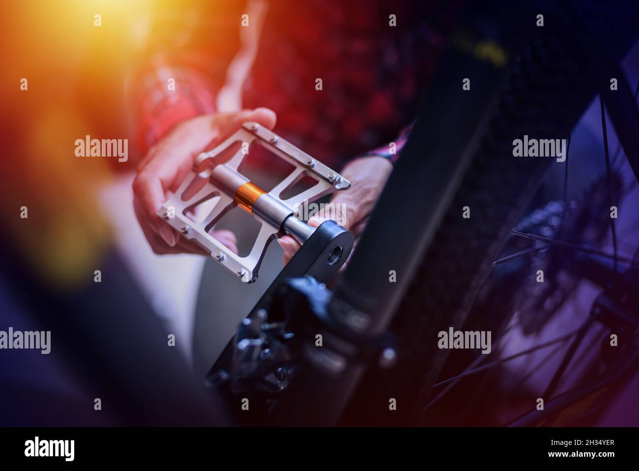 The man changing bike pedals. Mountain bike upgrade concept Stock Photo
