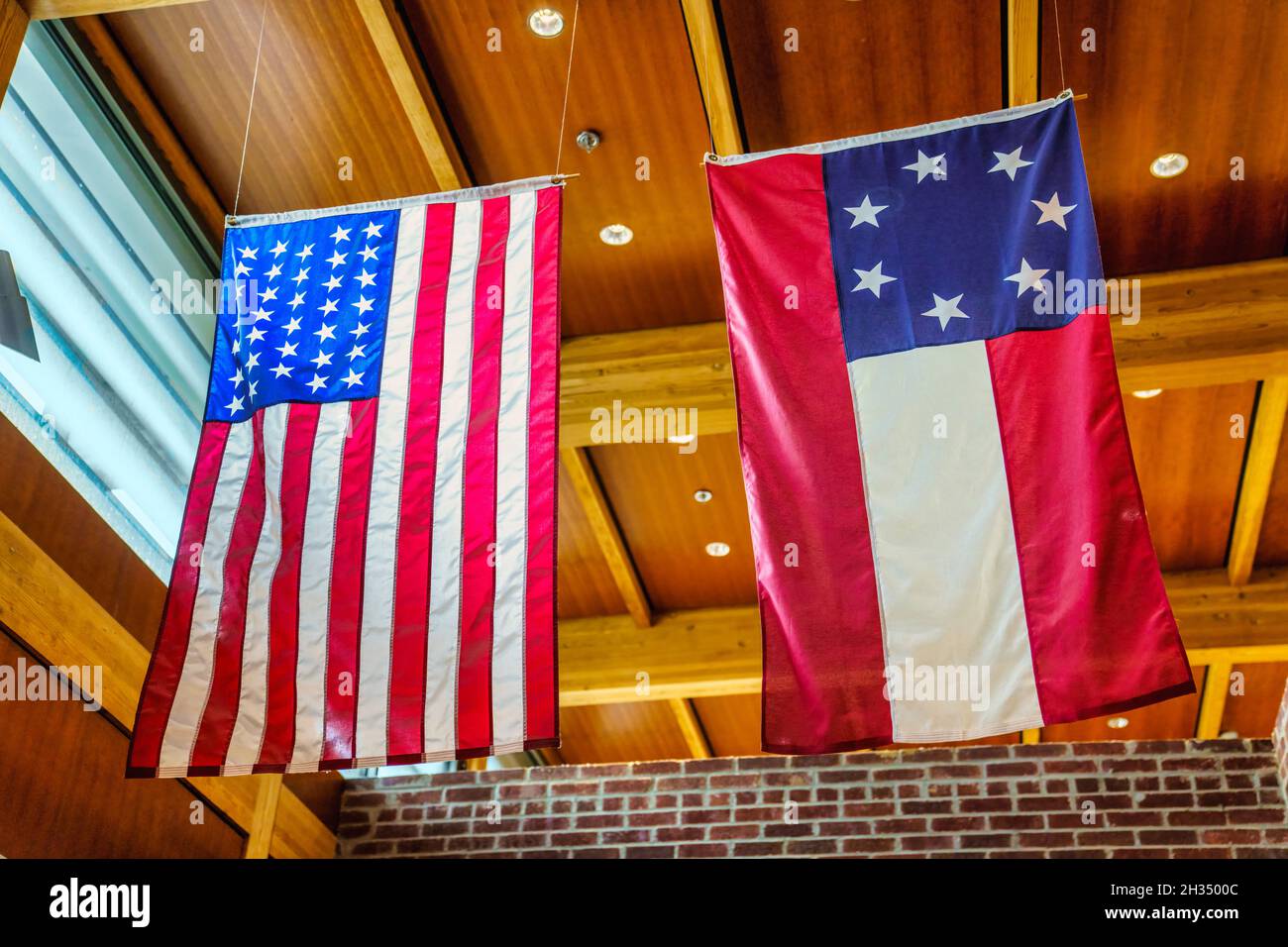 The American and Confederate flags hanging inside the Corinth Civil War Interpretive Center of Shiloh National Military Park in Mississippi. Stock Photo