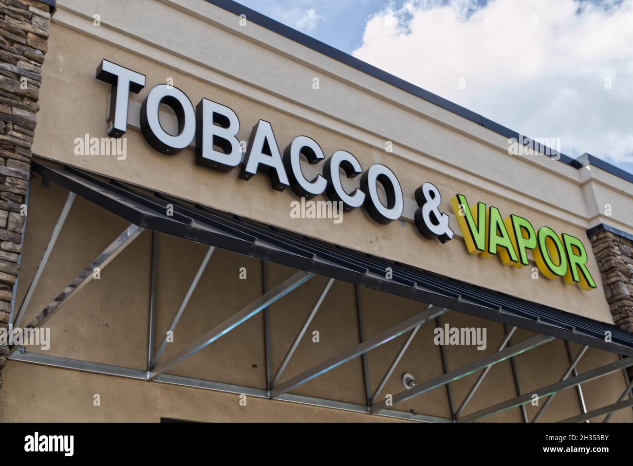 Tobacco and Vapor building sign and awning in Stock Photo Alamy