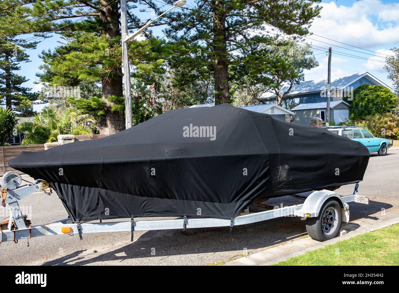 Trailer boat with protective cover parked in a Sydney street in Avalon