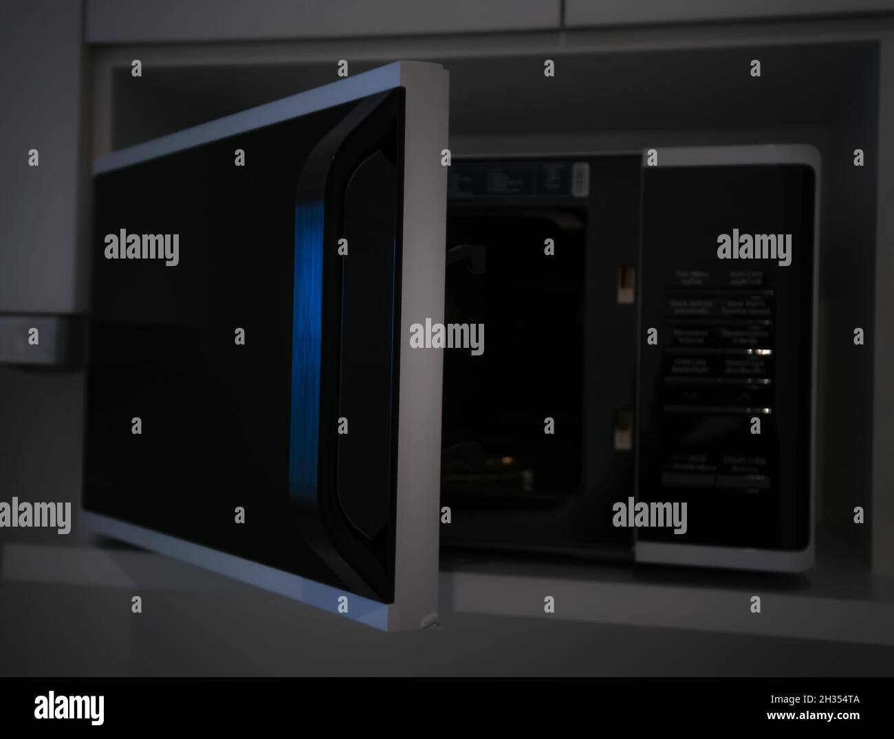 Microwave oven door and prepare food in the microwave, Dark tone Stock