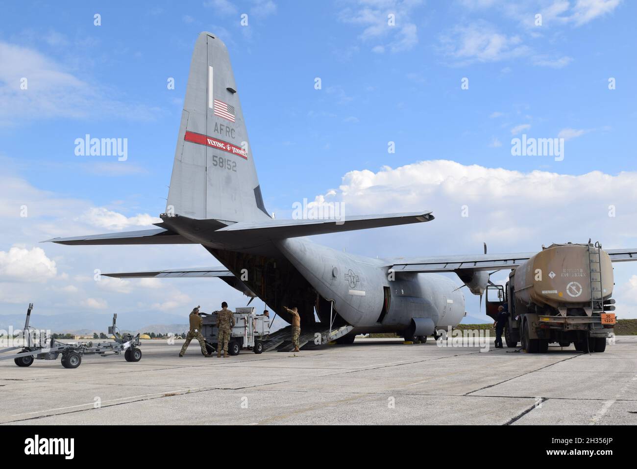 U.S. Air Force Airmen load cargo onto a U.S. Air Force Reserve C130J