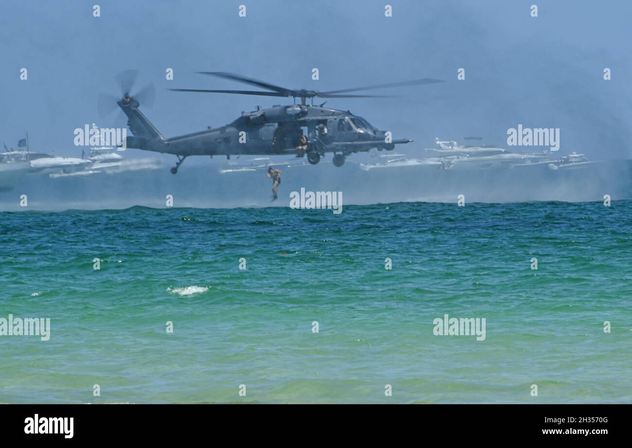 A Pararescuemen jumps into the ocean from a 920th Rescue Wing HH-60G Pave Hawk helicopter during a combat search-and-rescue demonstration at the 2021 National Salute to America's Heroes Air and Sea Show May 29, 2021. (U.S. Air Force photo by Master Sgt. Kelly Goonan) Stock Photo