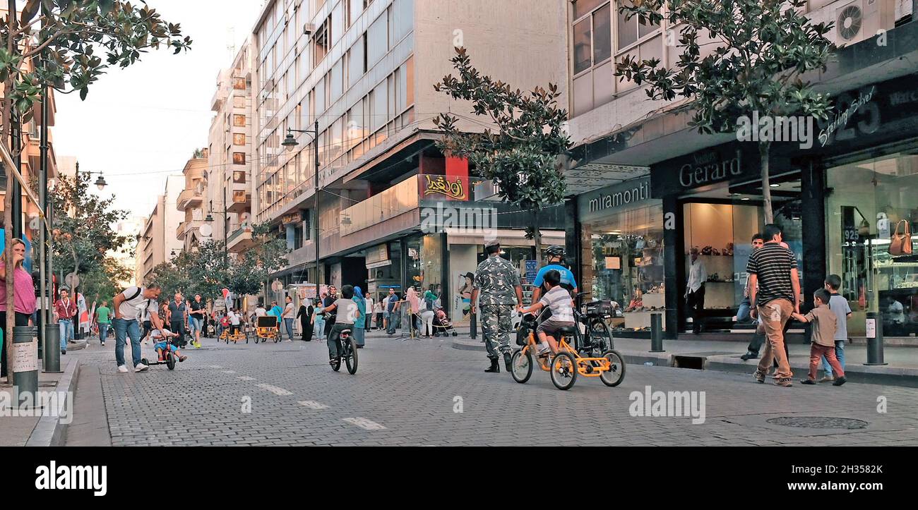 Lebanese take to the streets during the 2015 car free day on Hamra Street in the Hamra neighborhood of Beirut, Lebanon.  This event brought many pedestrians and bikers to the normally traffic clogged street giving people the opportunity to see how urban traffic changes the streetscape as well as the quality of life of residents. Stock Photo