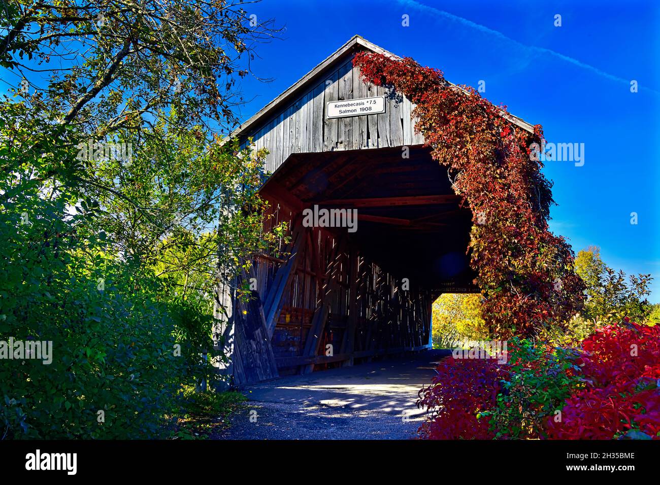 A one lane wooden covered bridge now retired and used as a park and tourist attraction near Smith Creek New Brunswick Canada. Stock Photo