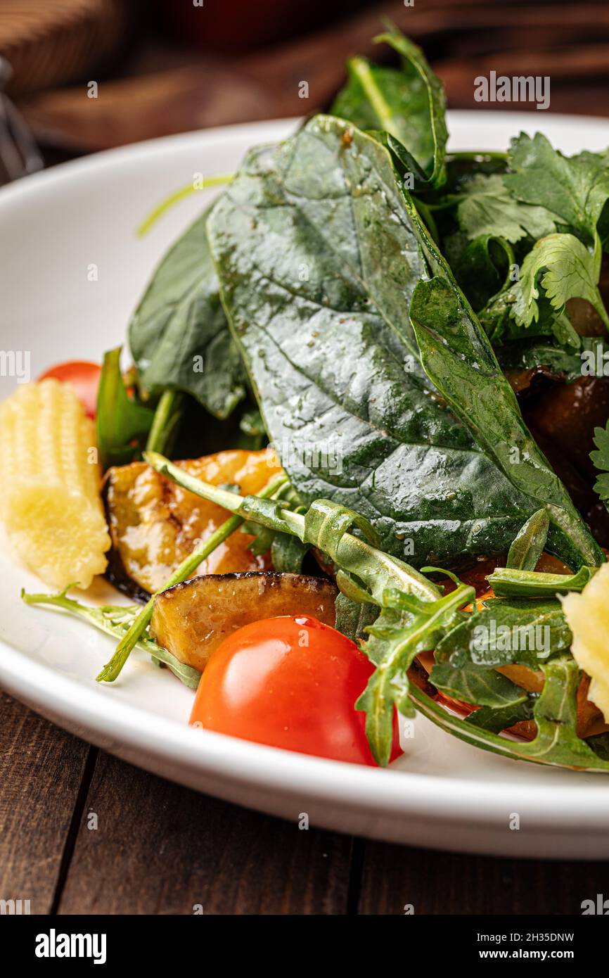 Healthy spinach salad with eggplant and baby corn Stock Photo