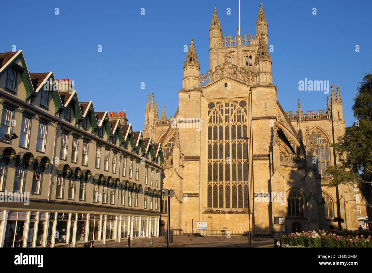 Bath Abbey (church) east front and period buildings glowing orange soon after sunrise in Bath, Somerset, England Stock Photo