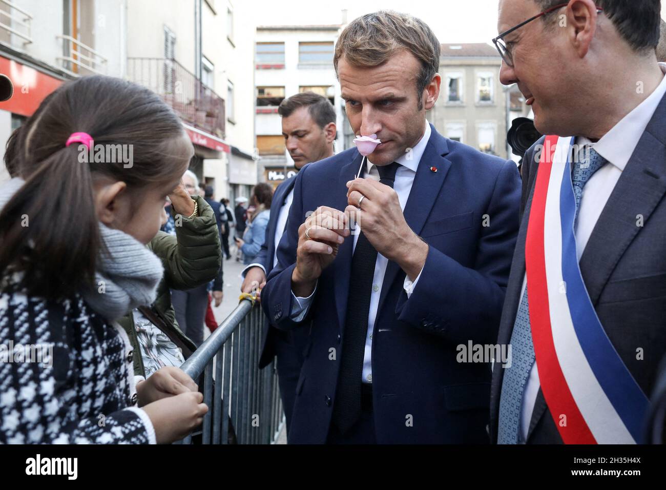 French President Emmanuel Macron is given a rose by a young girl during a  visit in Montbrison, central-eastern France, on October 25, 2021. Photo by  Stephane Lemouton/Pool/ABACAPRESS.COM Stock Photo - Alamy