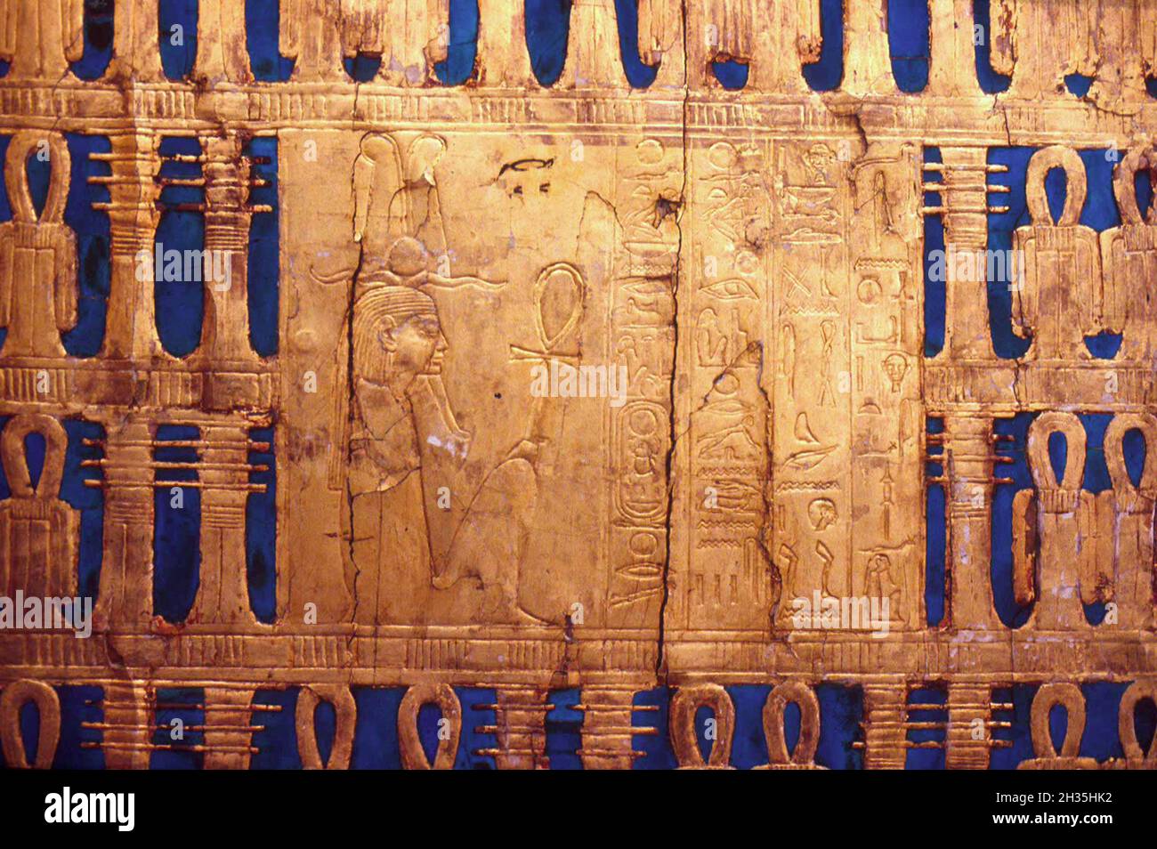 Outer golden side of shrine with alternating pairs of djed pillars (stability), and tiet knots (life) from Tutenkhamun's tomb with hieroglyphs, taken Stock Photo