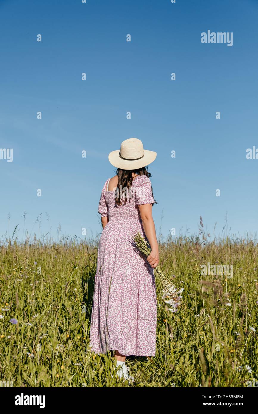 Woman walking field flowers hi-res stock photography and images - Alamy