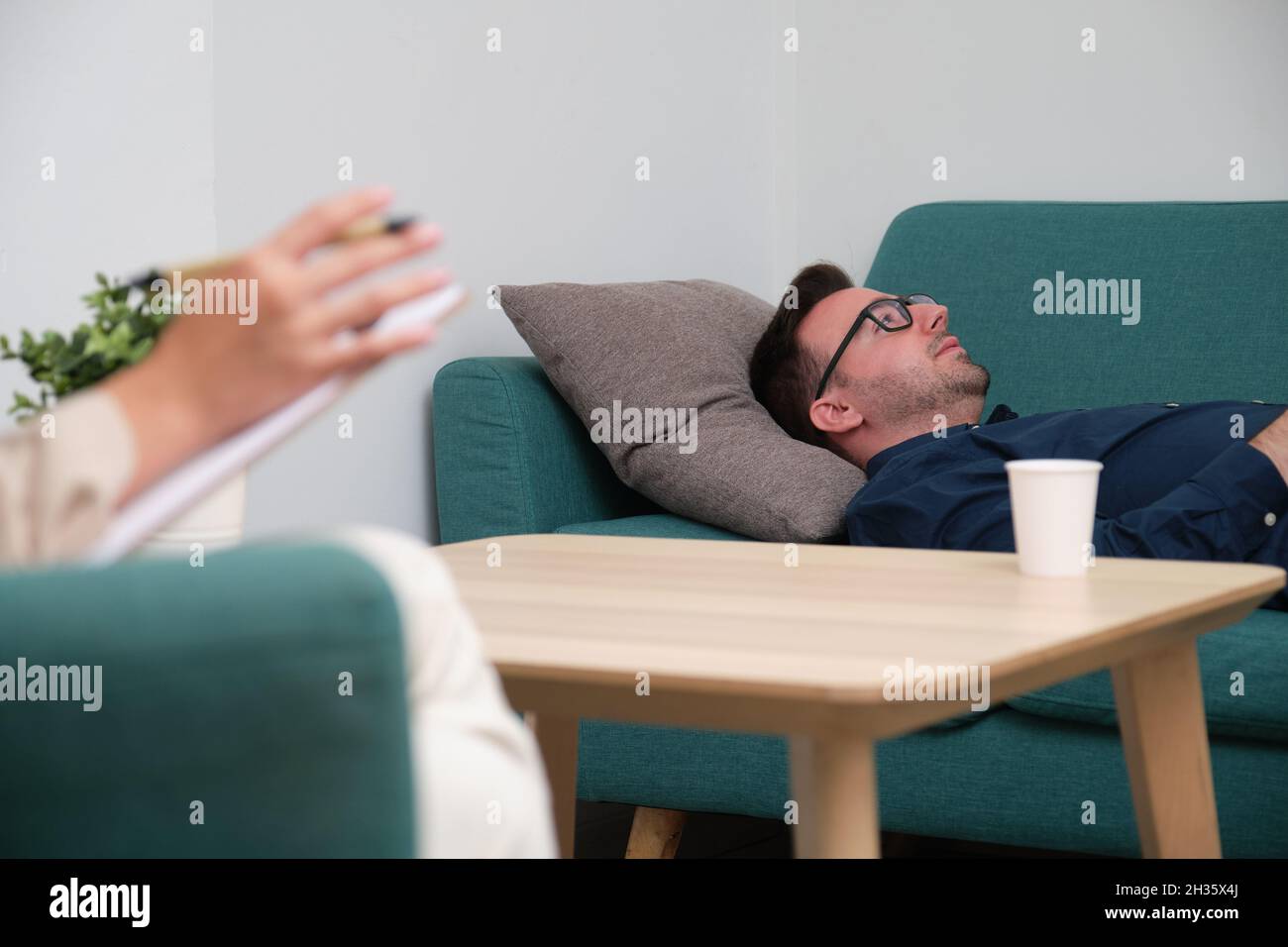 Caucasian man patient lying on a couch during the therapy. Stock Photo