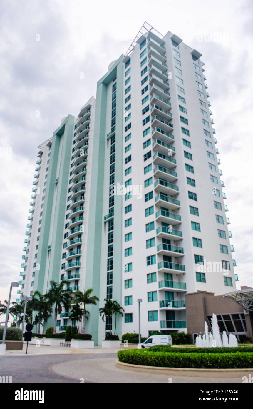 Vertical low angle of high-rise building against cloudy sky Stock Photo ...