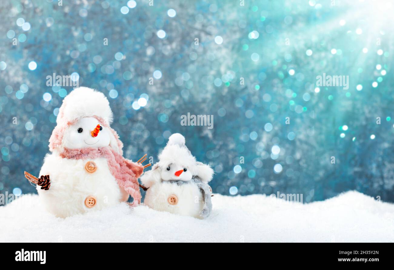 Christmas and new year snow concept with two cute snowmen in hats and ...