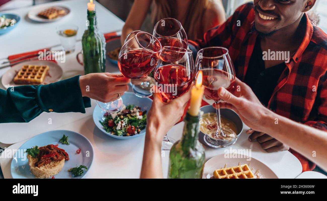 Friends Sitting Around Table Having Dinner Party. Stock Photo