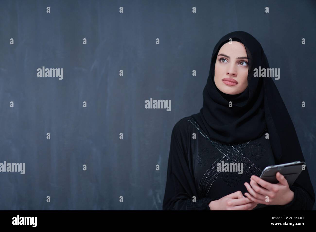 young modern muslim business woman holding tablet computer wearing ...