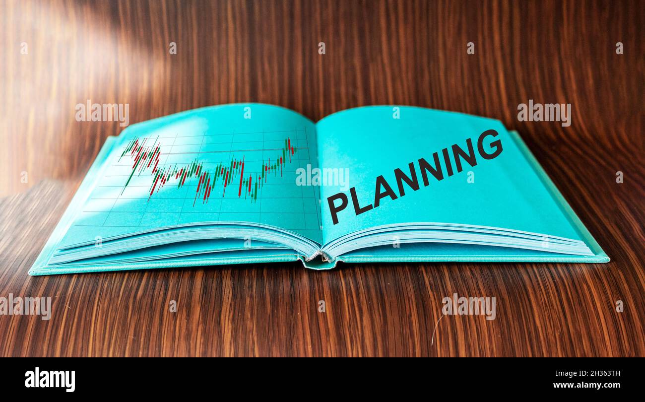 Planning, text written in green diary with growth chart. Wood