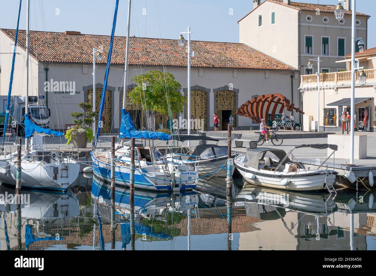 The harbour of Marseillan at the Étang de Thau with the company site of Noilly-Prat as backdrop, France Stock Photo