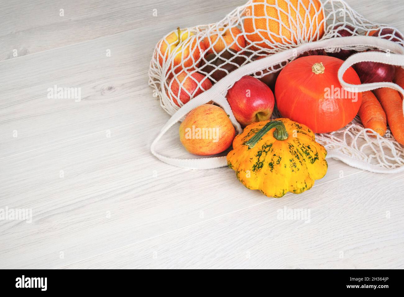 Fresh colorful organic vegetables coming out from eco shopping bag. Healthy food background. Flat lay. Copy space. Stock Photo