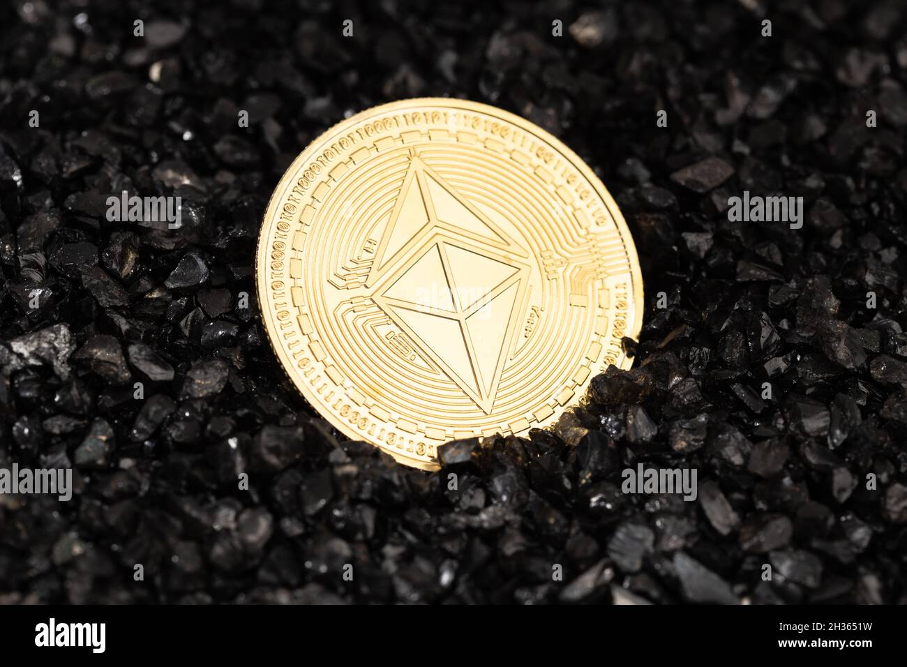 Ethereum classic coin on black gravel background. Cryptocurrency blockchain money Stock Photo