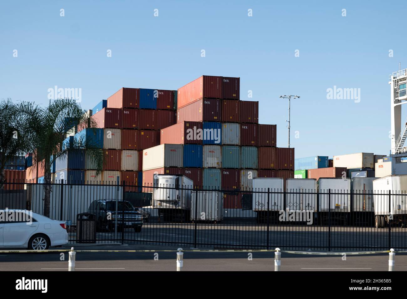 Los Angeles, CA USA - July 16, 2021: Shipping containers stacked near trucks at the Port of Los Angeles during supply chain disruption Stock Photo
