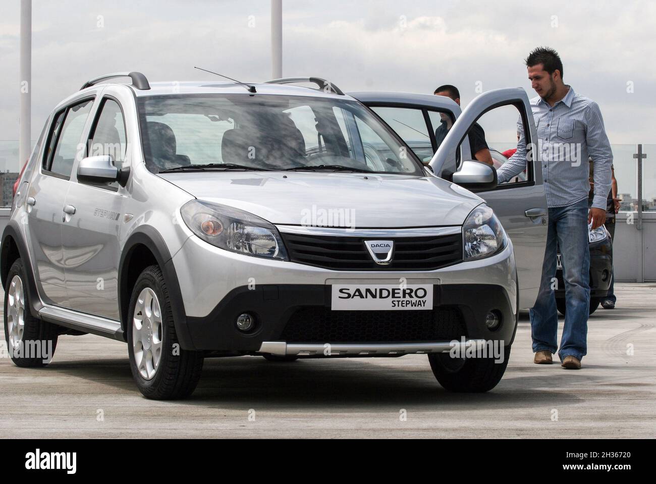 Bucharest, Romania, June 17, 2009: A man is looking at a Dacia Sandero model in a showroom in Bucharest. Stock Photo