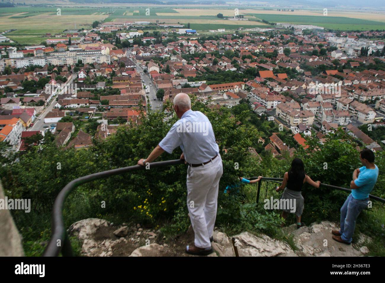 Rasnov, Romania, July 4, 2009: Visitors are looking at the panorama of Rasnov city from the Rasnov citadel, Romania. Stock Photo