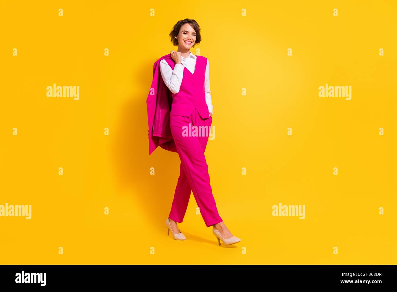 Photo of pretty charming young lady wear pink suit walking smiling ...