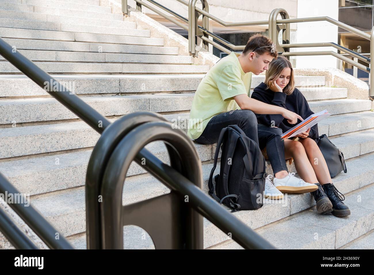 Two people sitting on stairs hi-res stock photography and images - Alamy