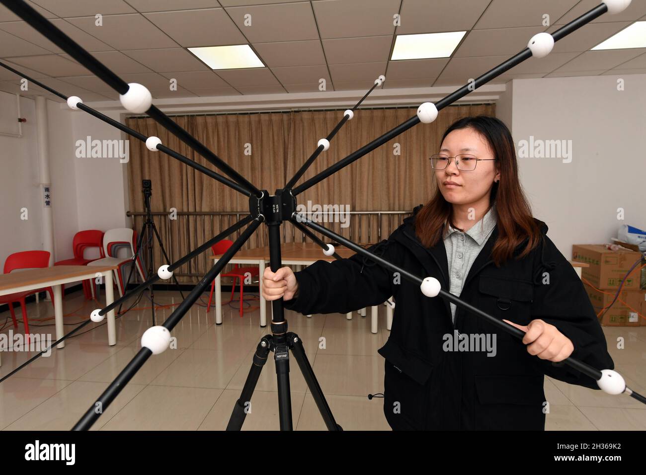 Beijing, China. 14th Oct, 2021. Chen Xue, a student of Professor Huo Bo, adjusts devices at the School of Astronautics, Beijing Institute of Technology, in Beijing, capital of China, Oct. 14, 2021. TO GO WITH 'China Focus: Smart tech serves as coaches for Beijing 2022 athletes' Credit: Ren Chao/Xinhua/Alamy Live News Stock Photo