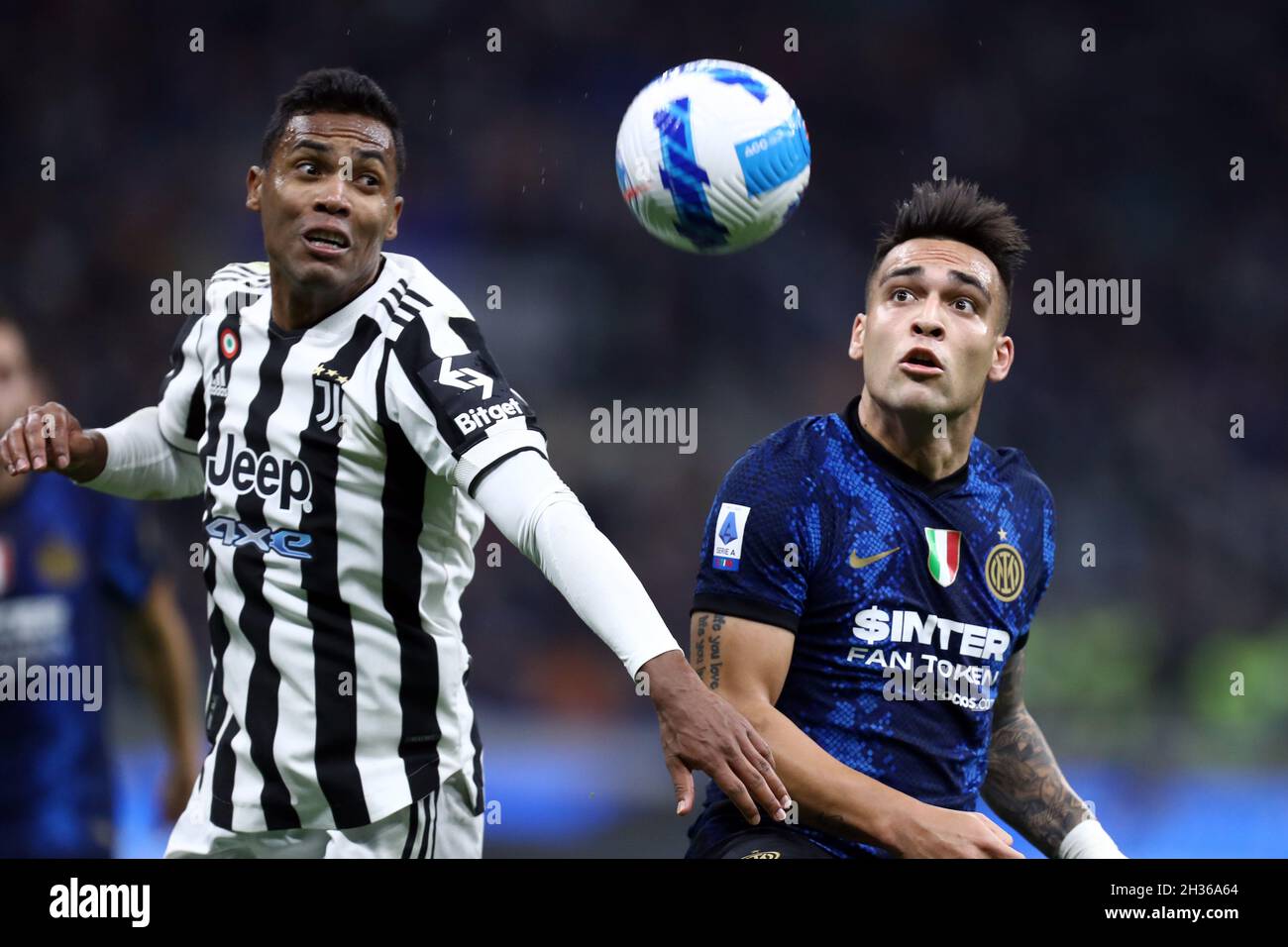 Alex Sandro of Juventus Fc and Lautaro Martinez of Fc Internazionale  battle for the ball during the Serie A match between Fc Internazionale and Juventus Fc . Stock Photo