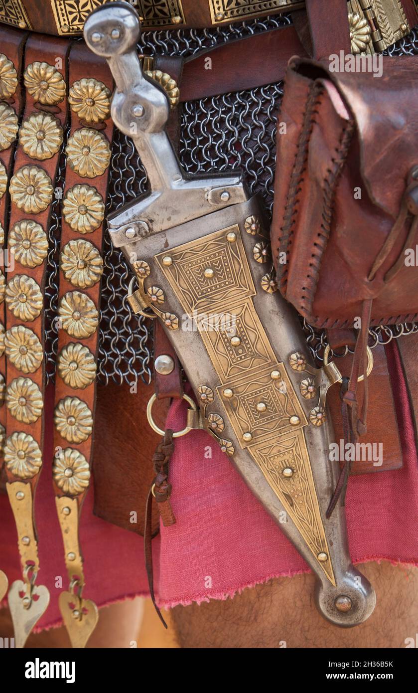 Centurion girding a pugio, a dagger used by roman soldiers as a sidearm. Historical reenactment Stock Photo