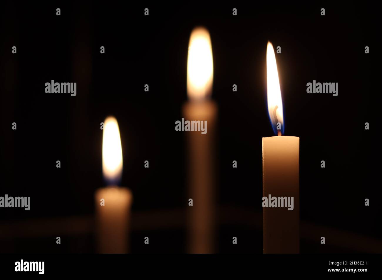 Candles burning in a dark room. Burning candles Stock Photo Alamy
