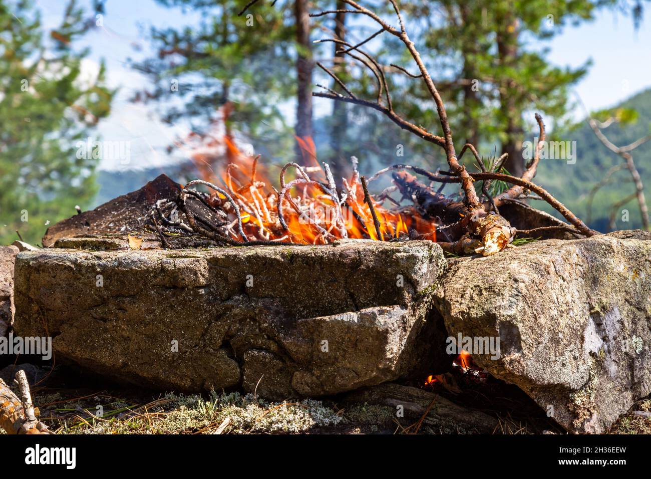 Fishermen's bivouac on the island. A burning bonfire. Lake Tagasuk. Krasnoyarsk Territory, Siberia, Russia Stock Photo