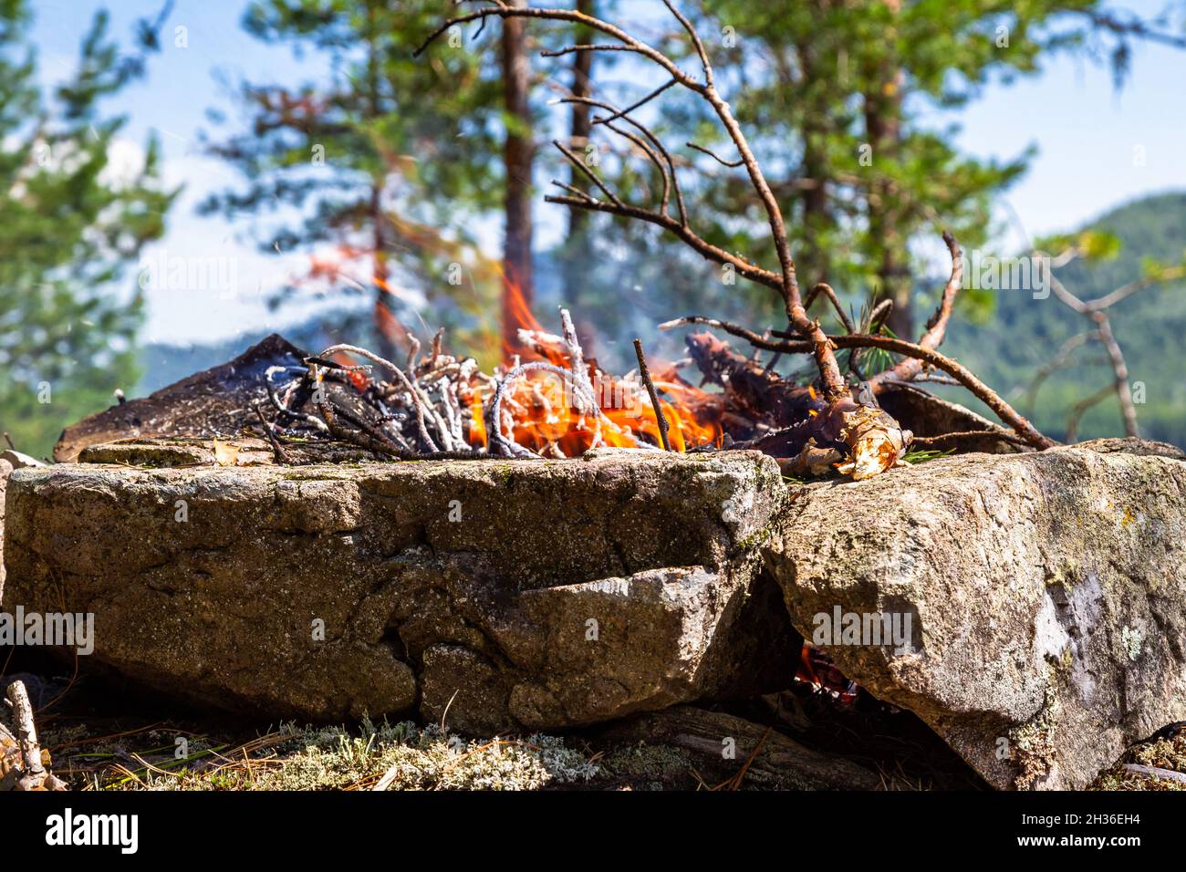 Fishermen's bivouac on the island. A burning bonfire. Lake Tagasuk. Russia Stock Photo