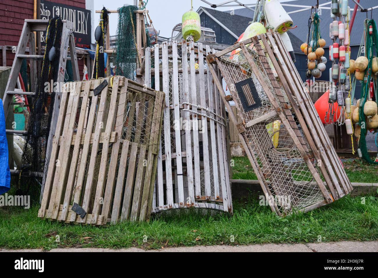 Stack of wooden vintage lobster traps on offer at local Chandlery store
