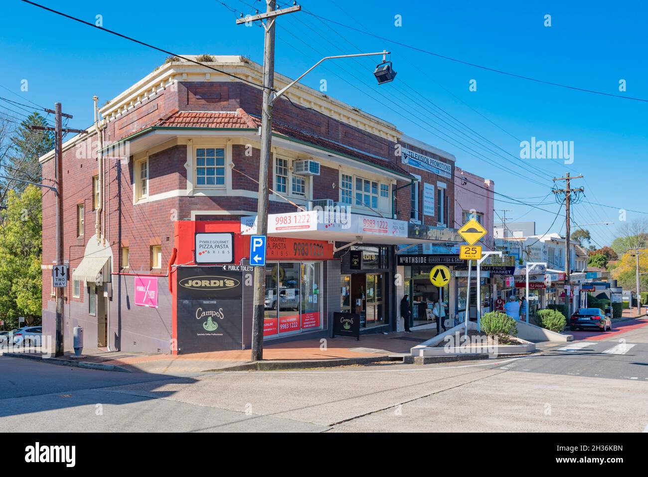 A two storey interwar brick building on the corner of the shopping strip on Grandview Lane and Grandview Avenue in Pymble, New South Wales, Austral Stock Photo