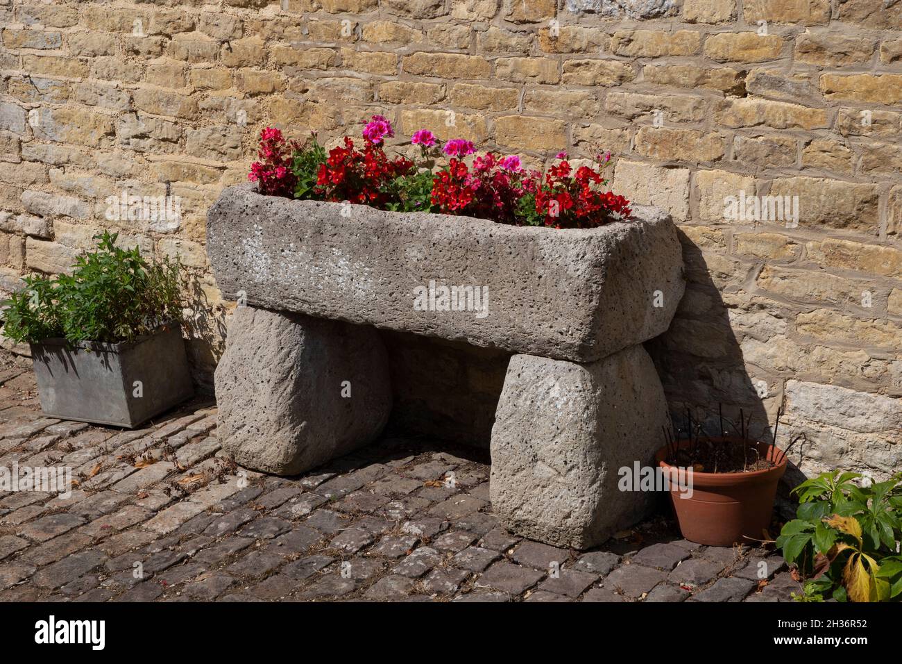 Sone summer garden display trough in english garden Stock Photo