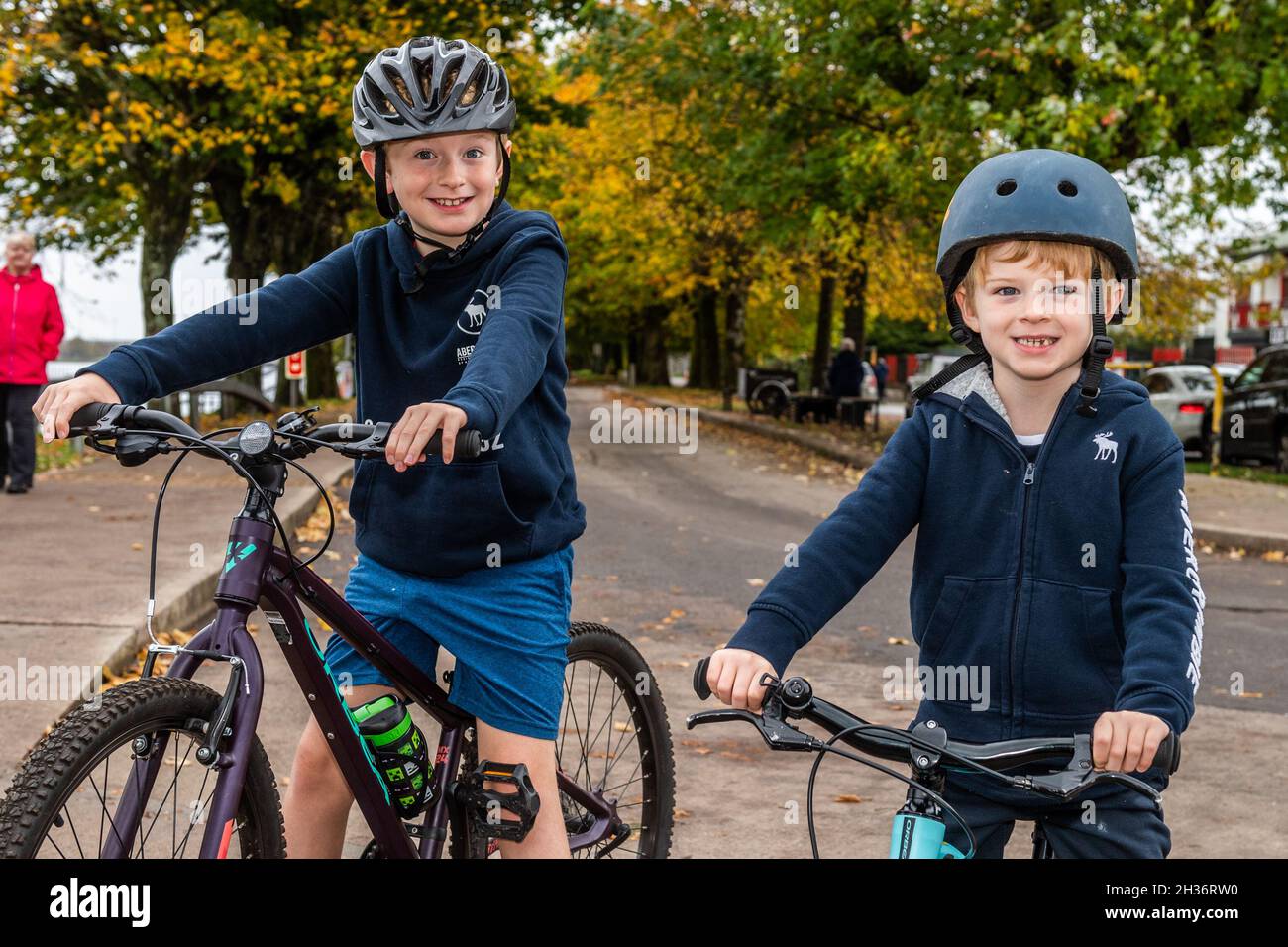 Cork, Ireland. 26th Oct, 2021. On a breezy but warm day, Colm and James Walsh from Ballinlough enjoy a bike ride on the Marina in Cork. Credit: AG News/Alamy Live News Stock Photo