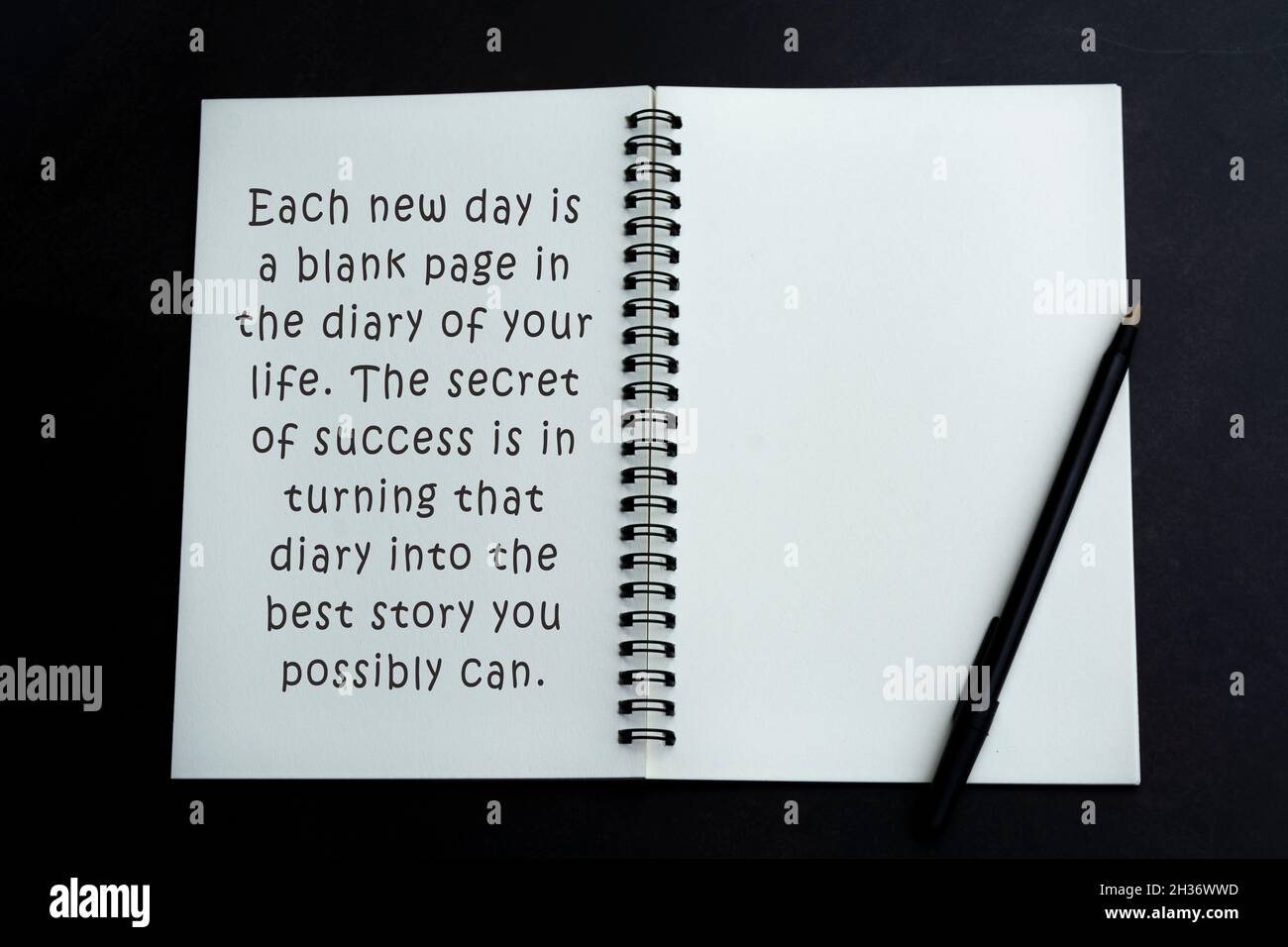 Motivational and inspirational quote on white notebook on dark background Stock Photo
